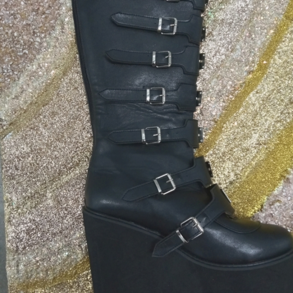 Buckle knee high platform wedge boots.